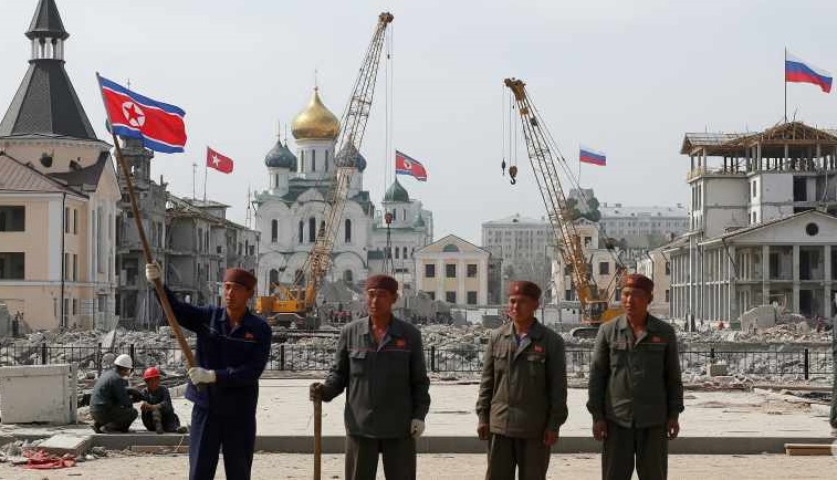A stylized image showing a handshake between two figures representing North Korea and Russia, with a backdrop of a partially rebuilt city.
